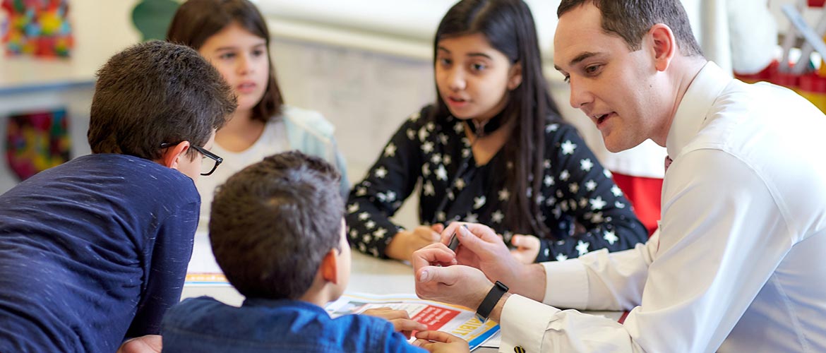 Children and a bank employee volunteer at a MoneySense workshop