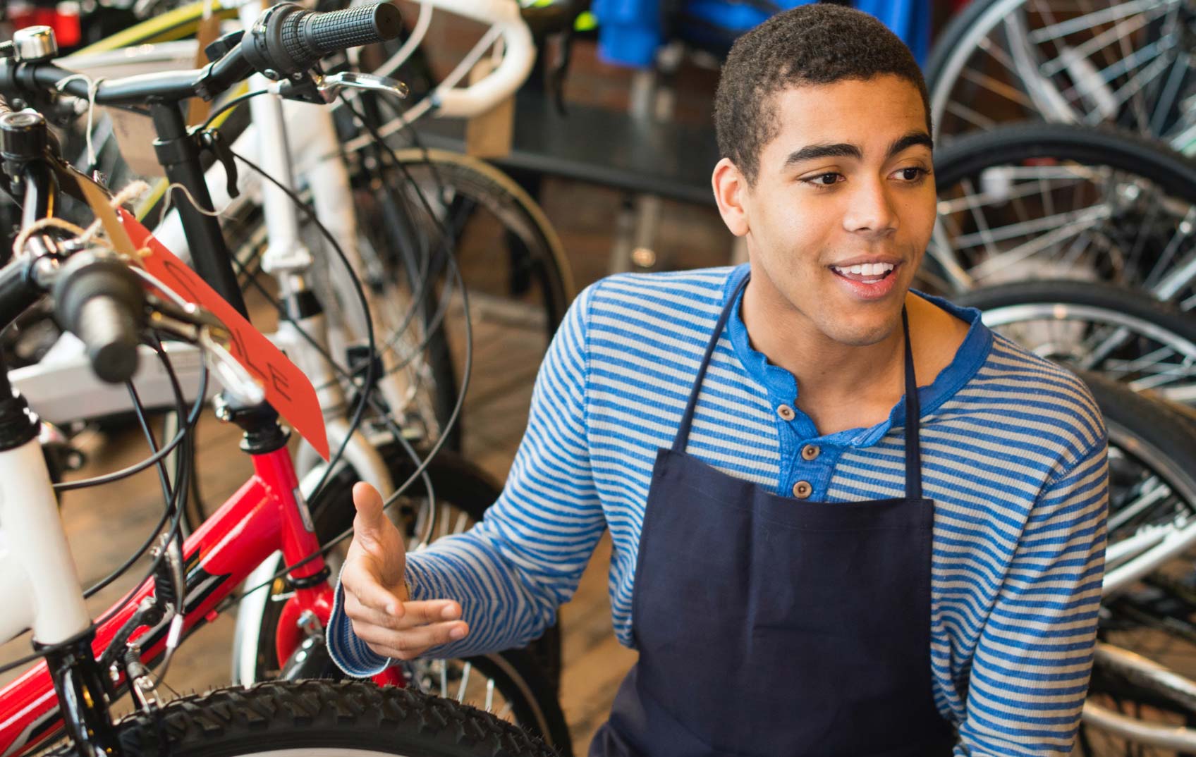 A young boy works fixing bicycles